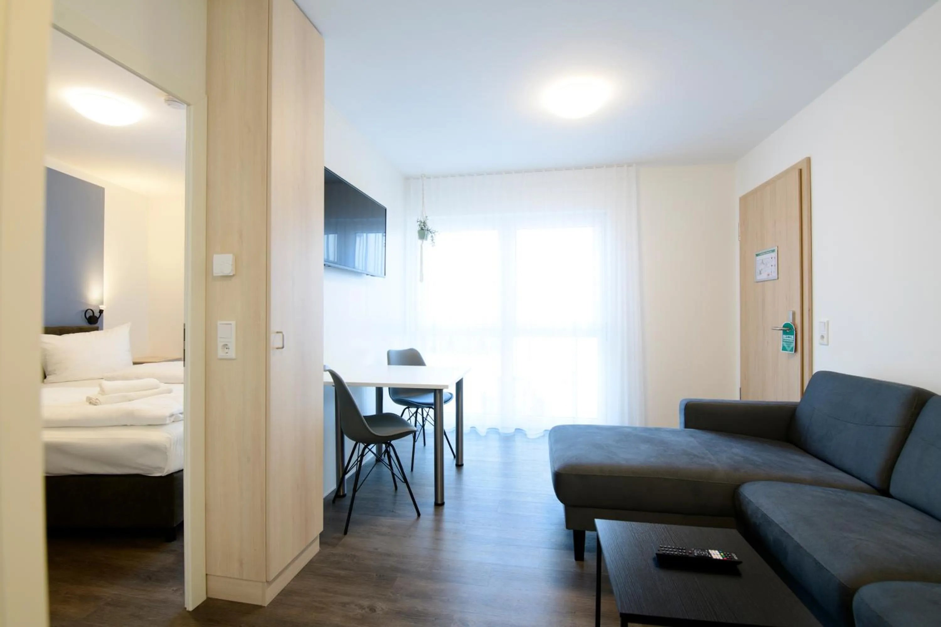 Living room, Bed in Smart & Stay Aparthotel Saarbrücken Süd - Self-Check-In - Free Parking