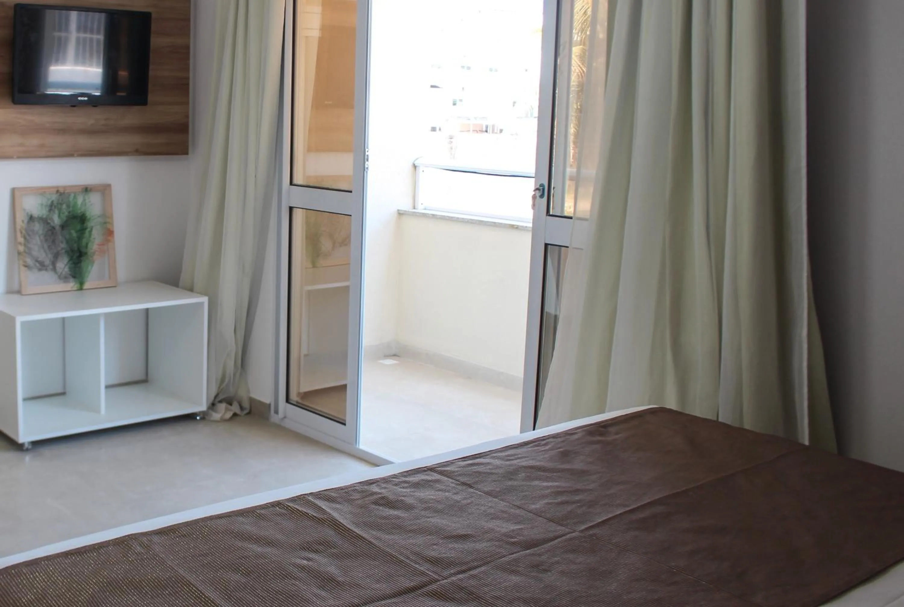 Bed in Pousada Jardins Tropical