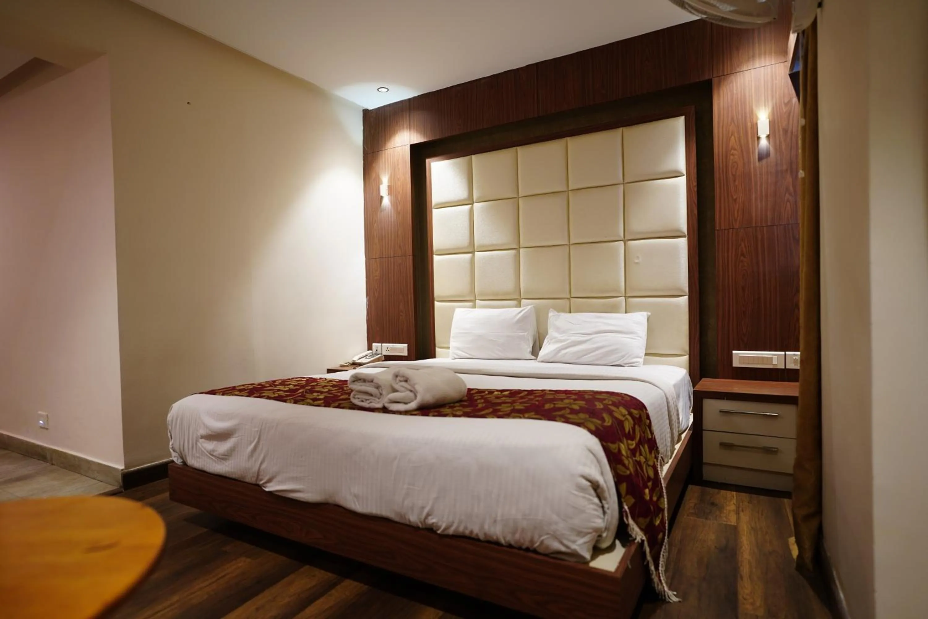 Bed in Emarald Hotel Calicut