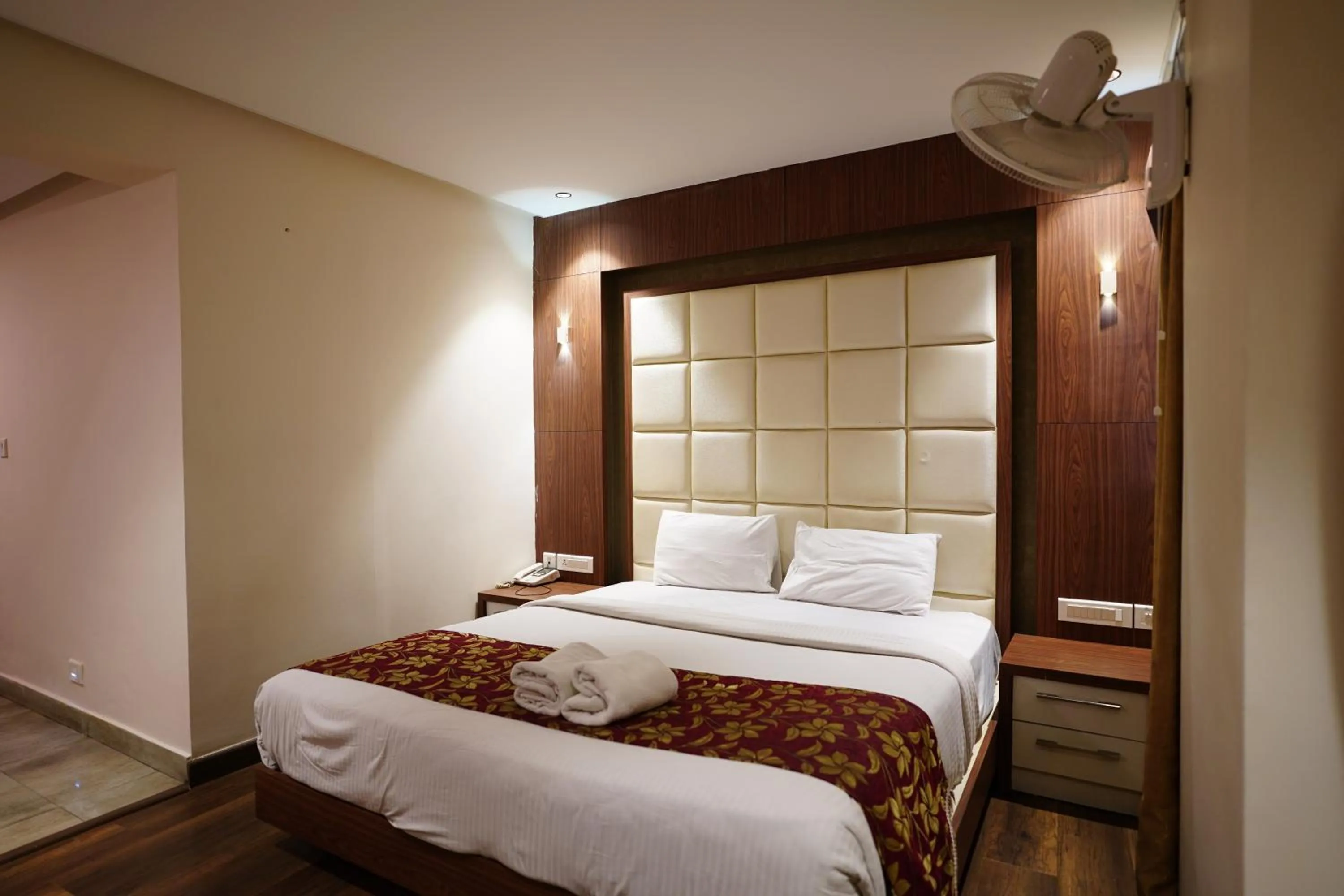 Bed in Emarald Hotel Calicut