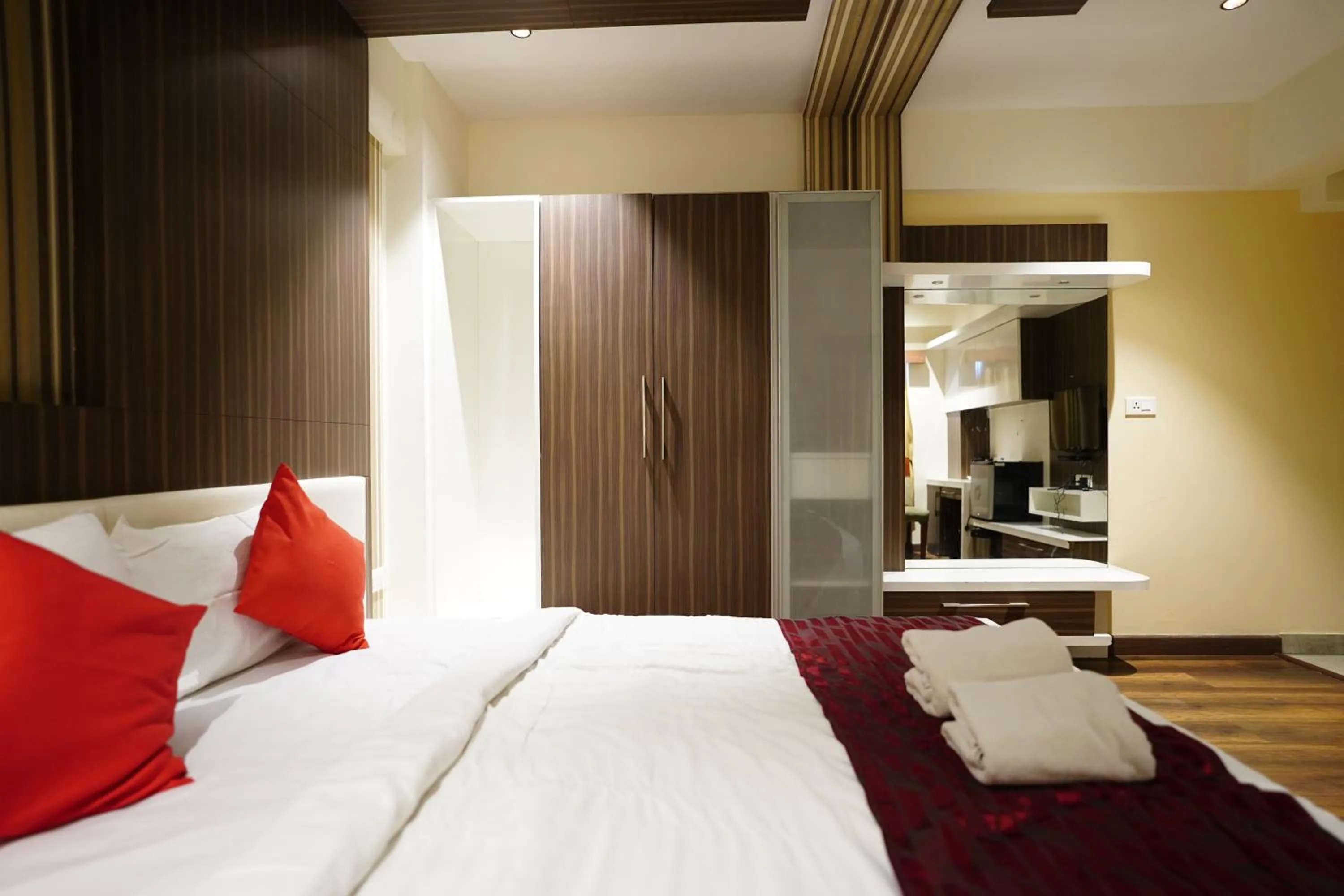 Bed in Emarald Hotel Calicut