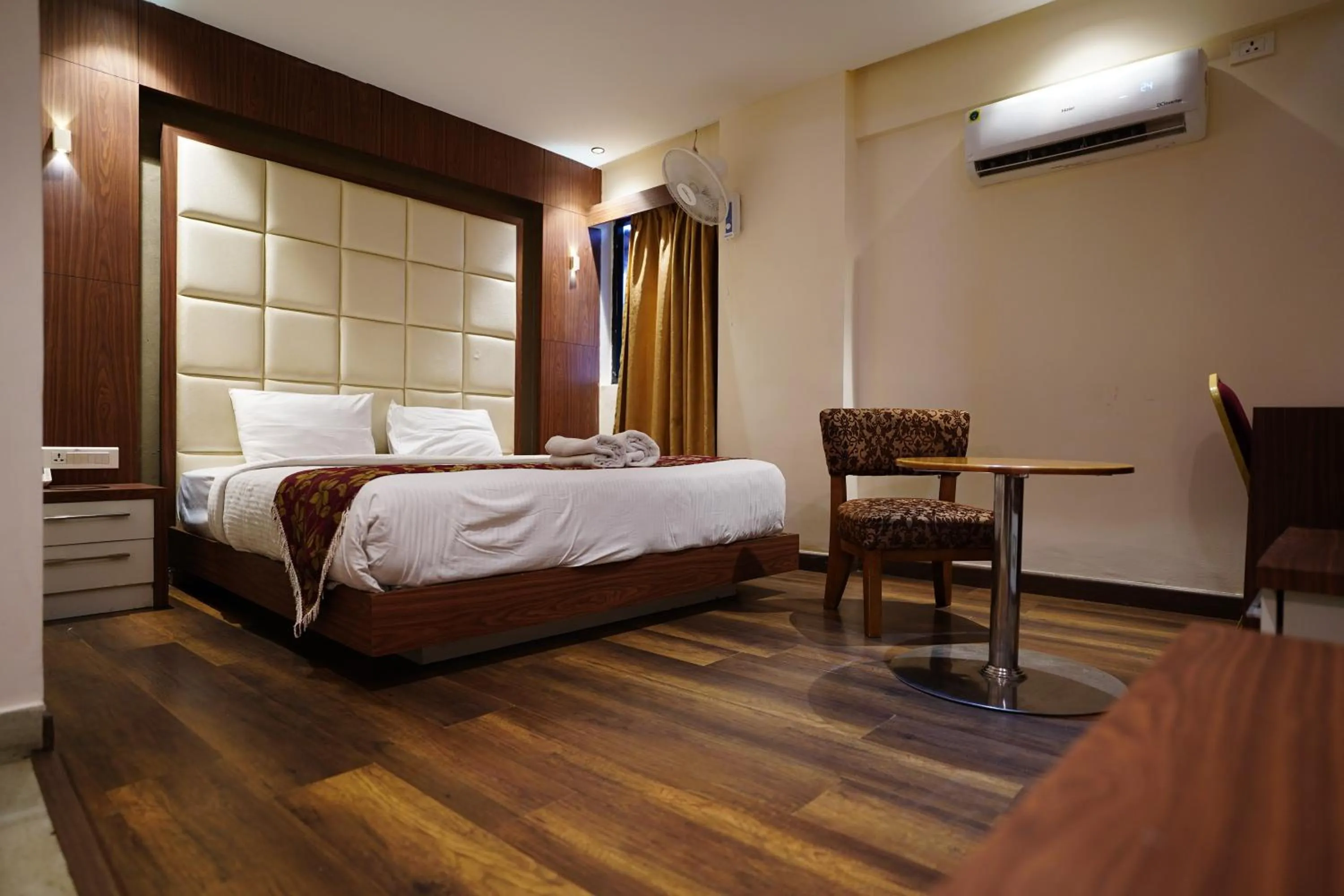 Bed in Emarald Hotel Calicut