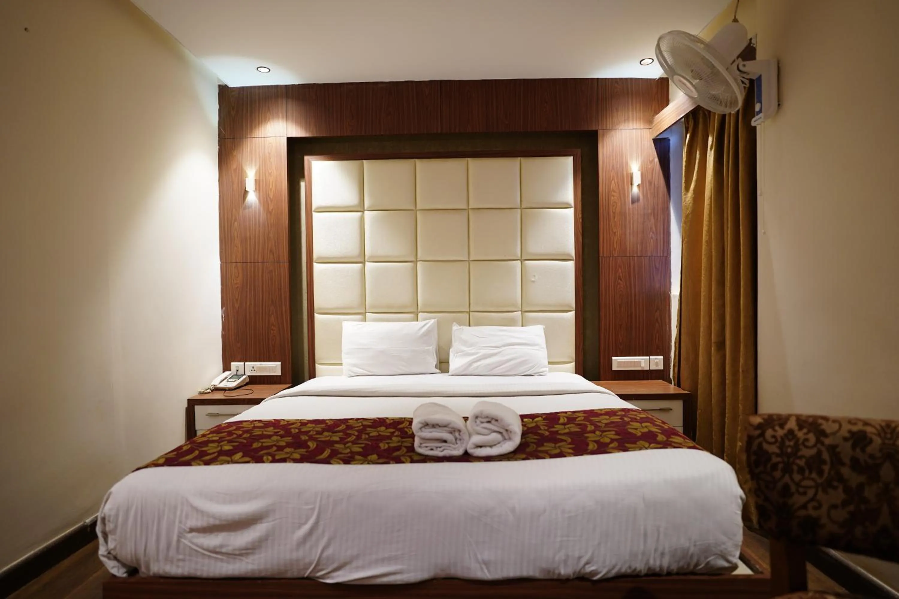 Bed in Emarald Hotel Calicut