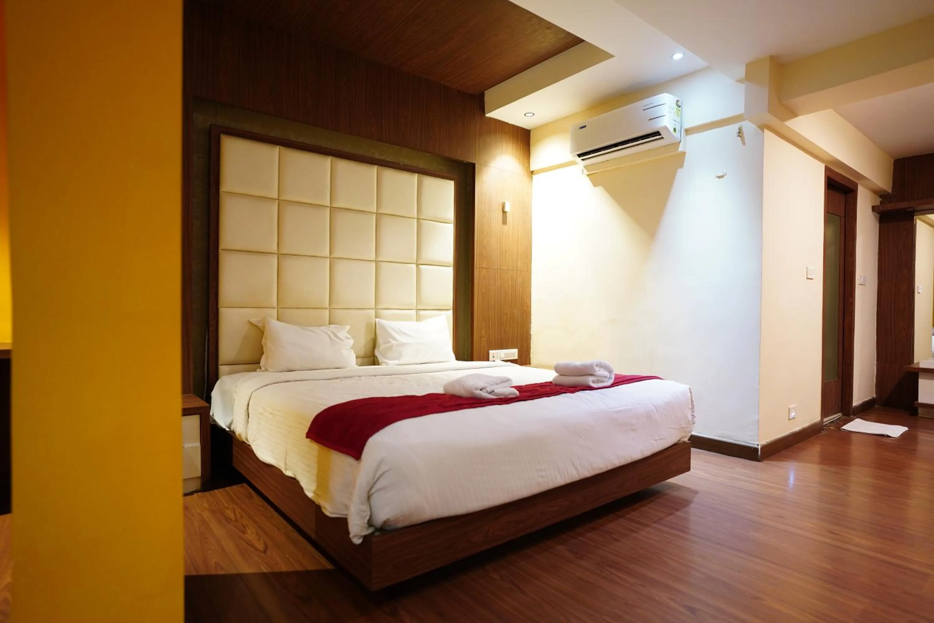 Bed in Emarald Hotel Calicut