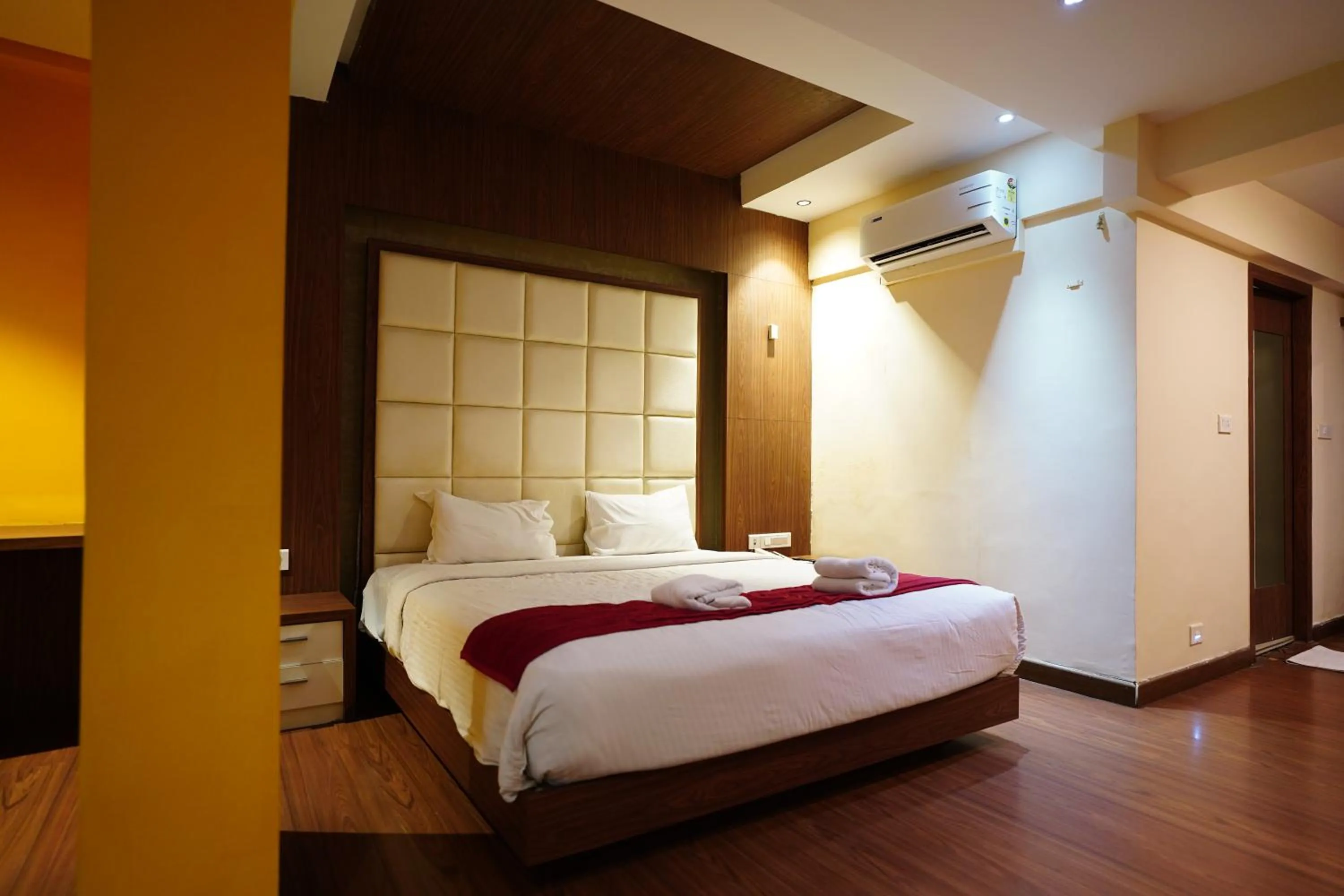 Bed in Emarald Hotel Calicut