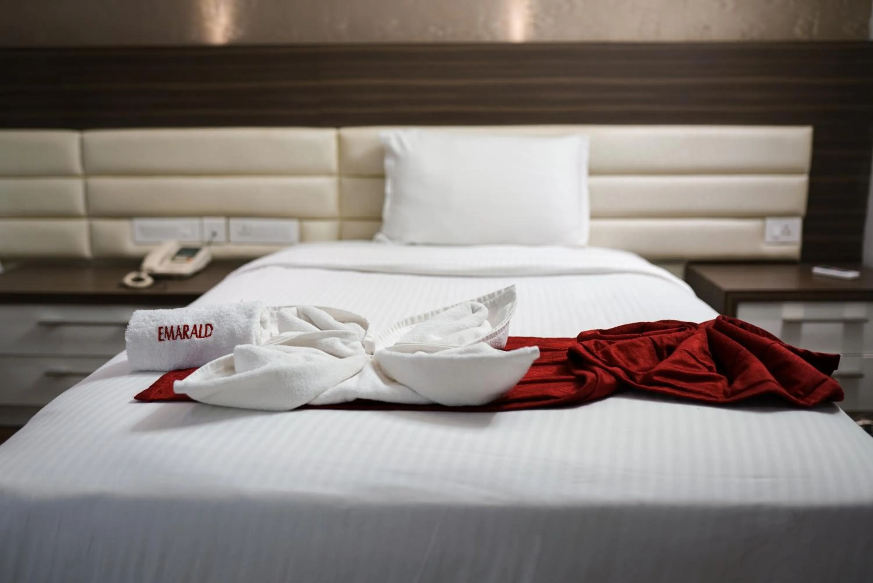 Bed in Emarald Hotel Calicut