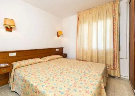 Bed in Apartamentos Guitart Bed in Apartamentos Guitart