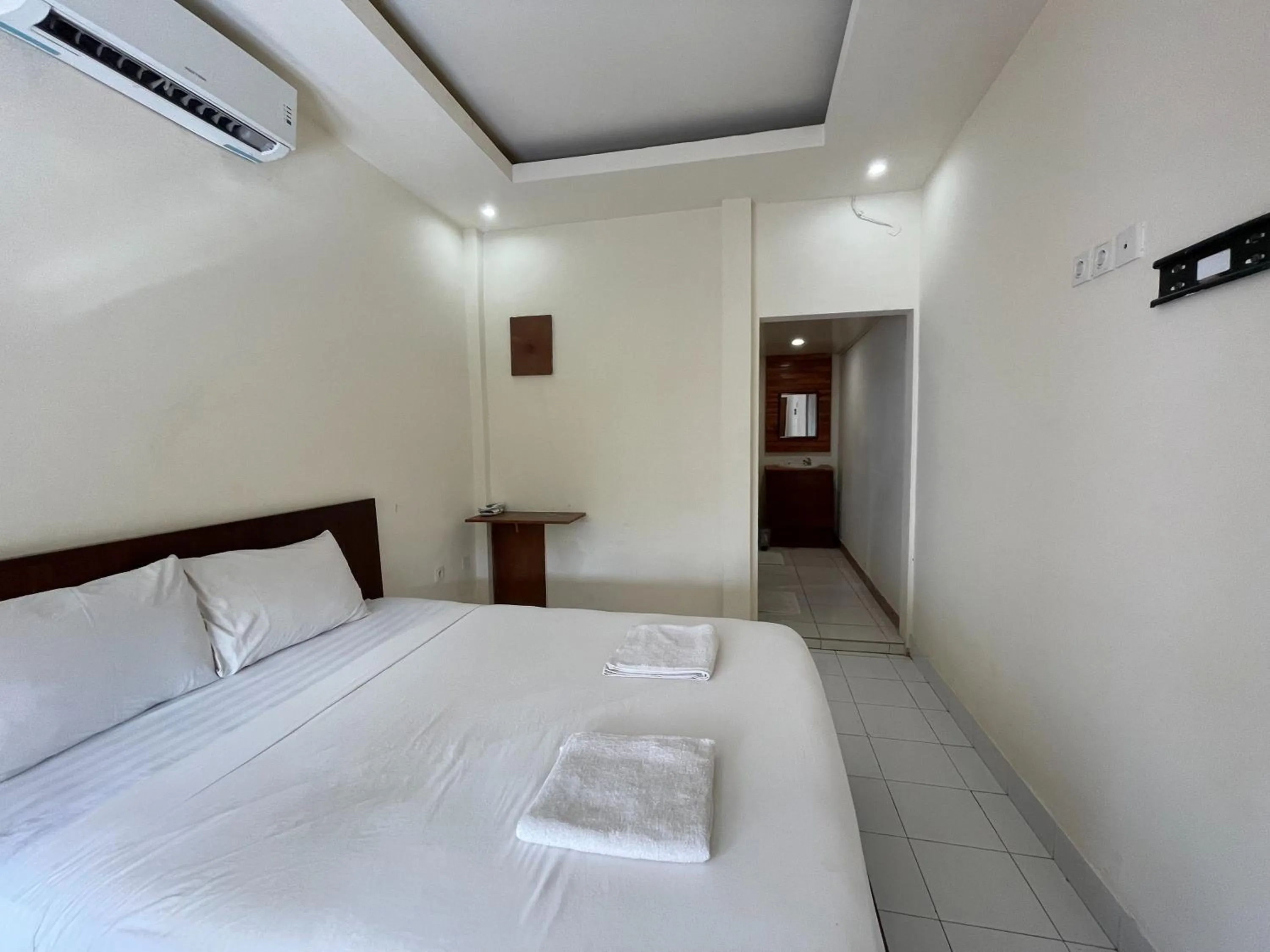 Bed in Melati Resort & Hotel Kuta Lombok