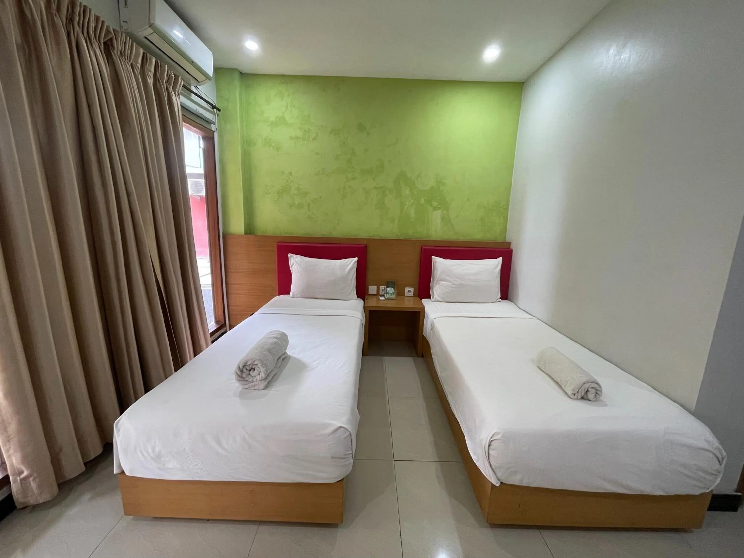 Bed in Melati Resort & Hotel Kuta Lombok
