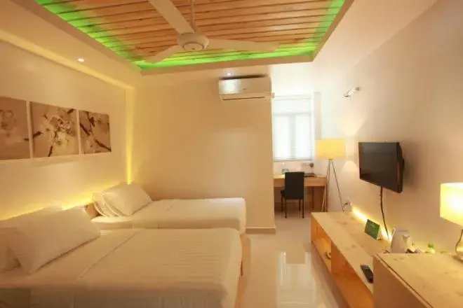 Bed in PINE LODGE MALDIVES Bed in PINE LODGE MALDIVES