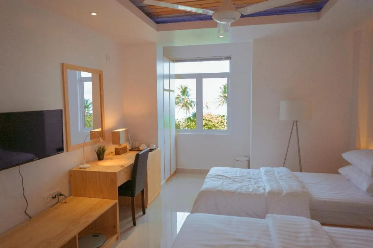 Bed in PINE LODGE MALDIVES