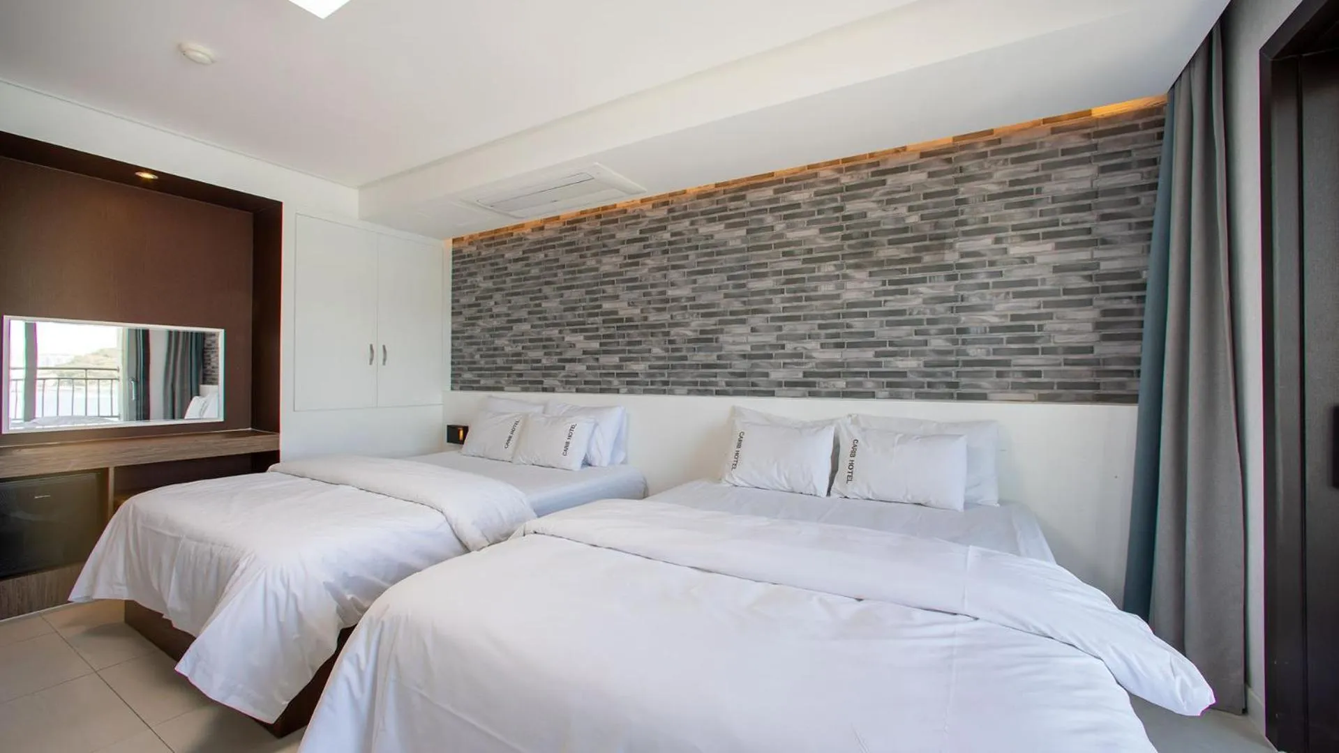 Bed in Carib Condo Hotel