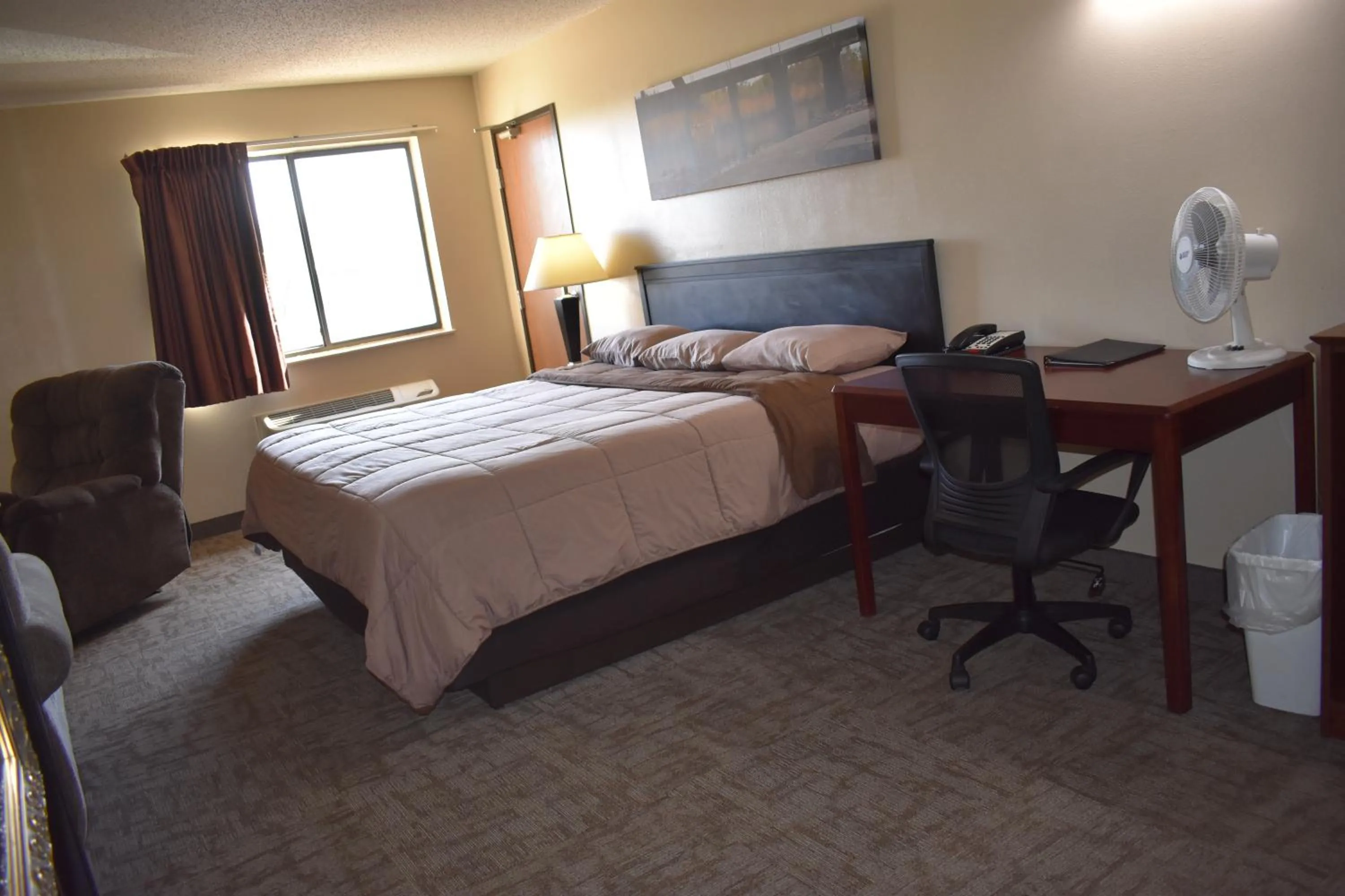 Bed in Heartland Hotel & Suites