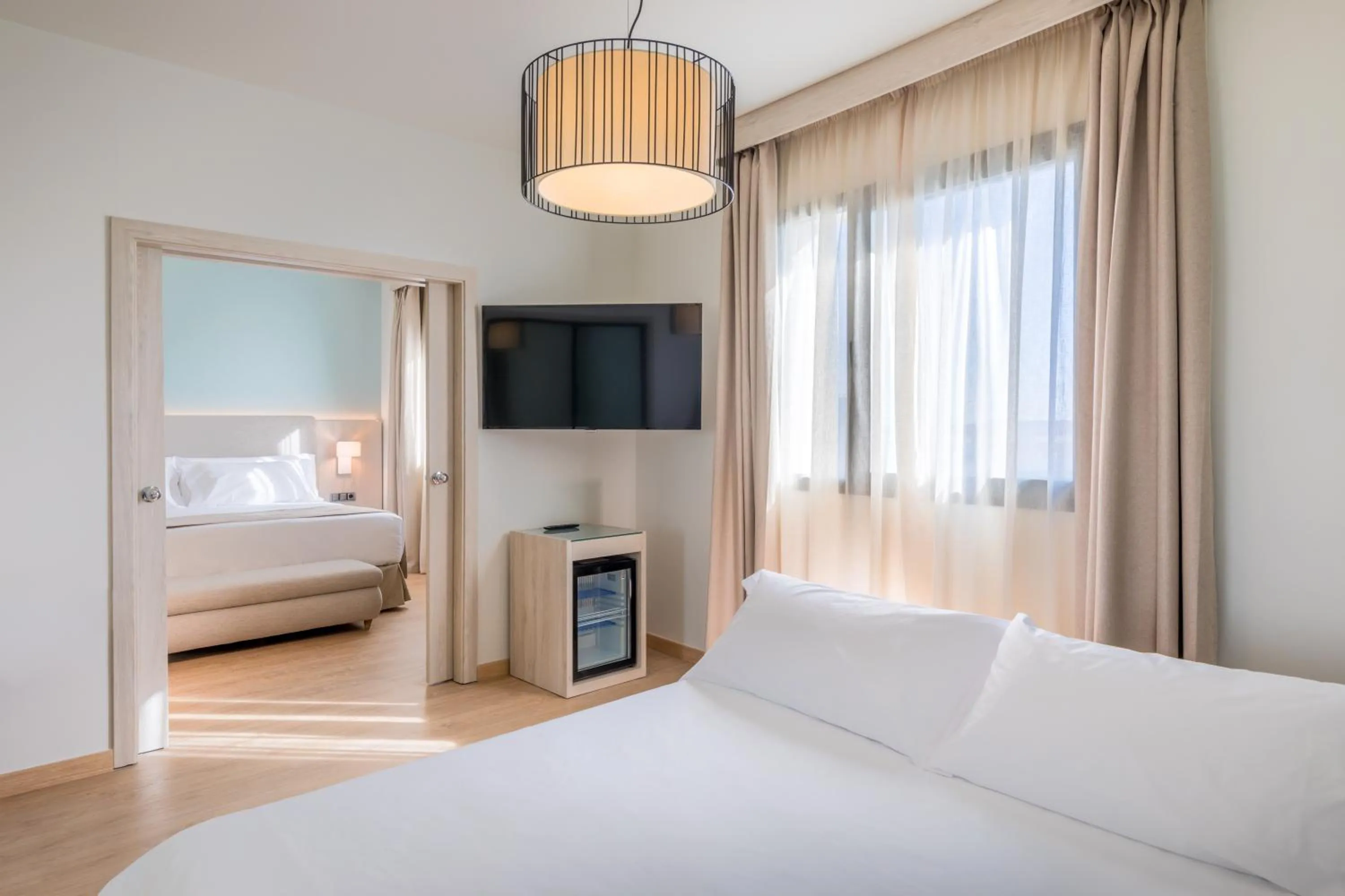 Seating area, Bed in Occidental Sevilla Viapol