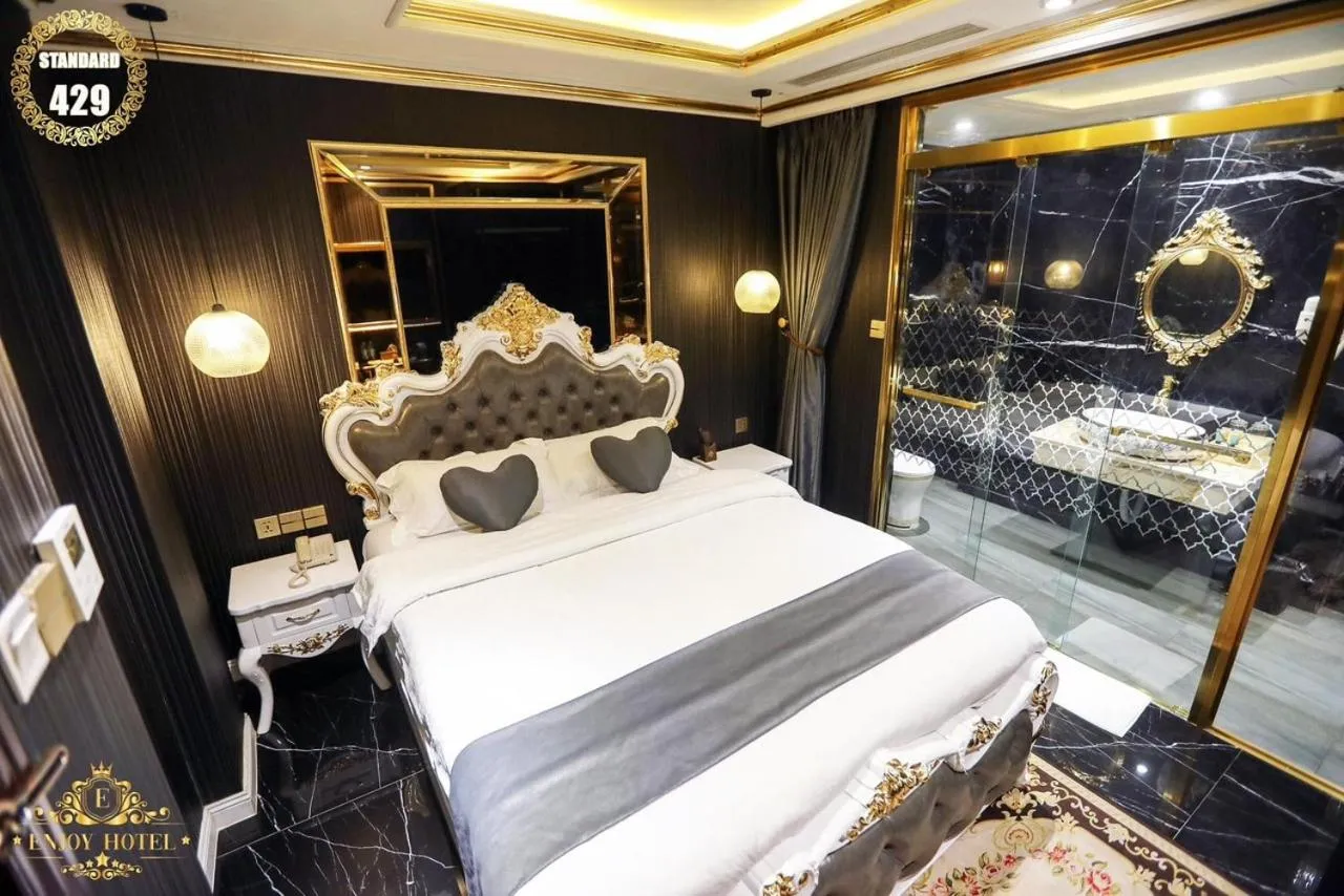 Bed in Enjoy Boutique Saigon Hotel