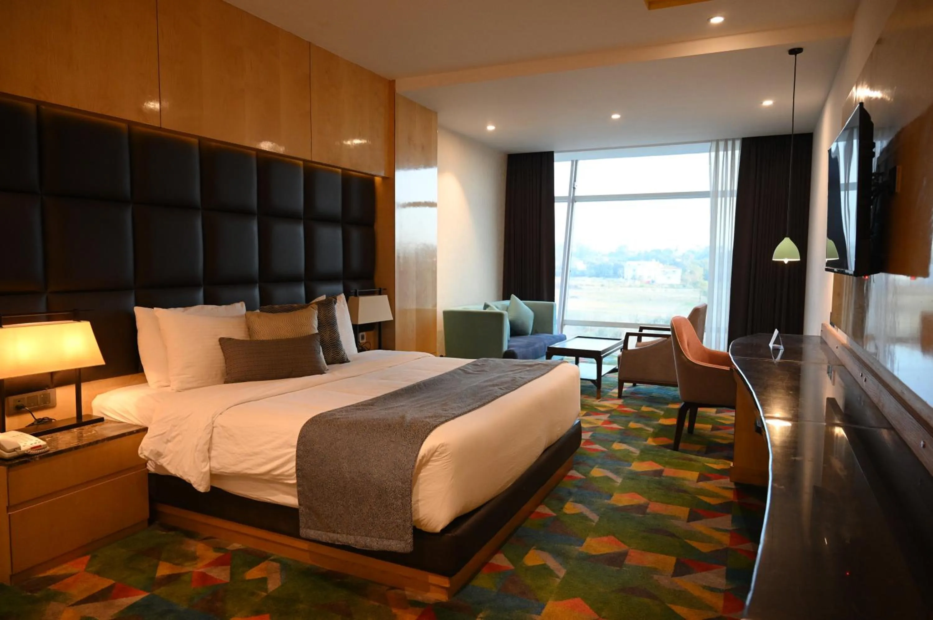 Seating area, Bed in Ramada Plaza by Wyndham Jammu Vijaypur