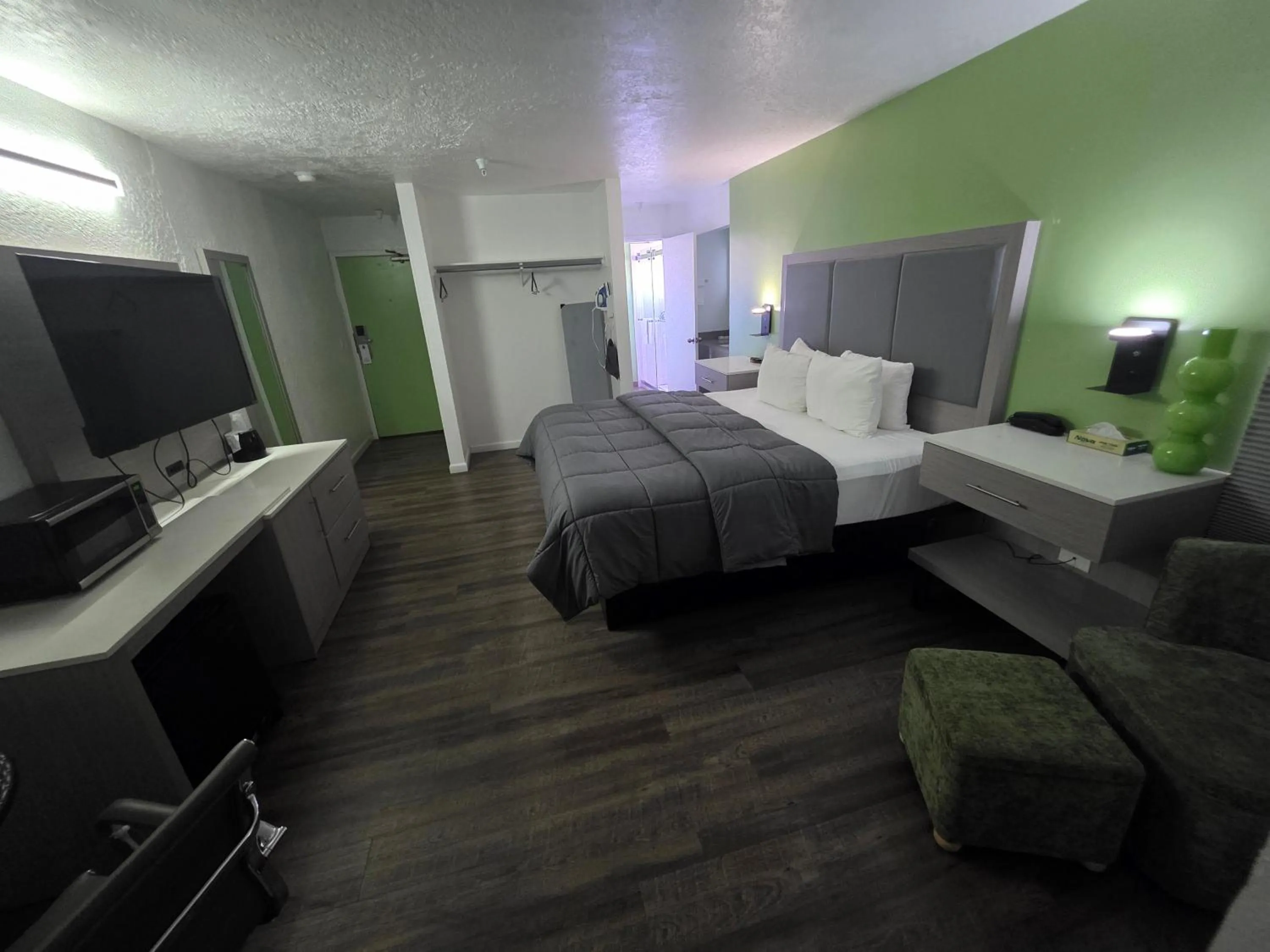 Bed in The Aqua Pacific Hotel