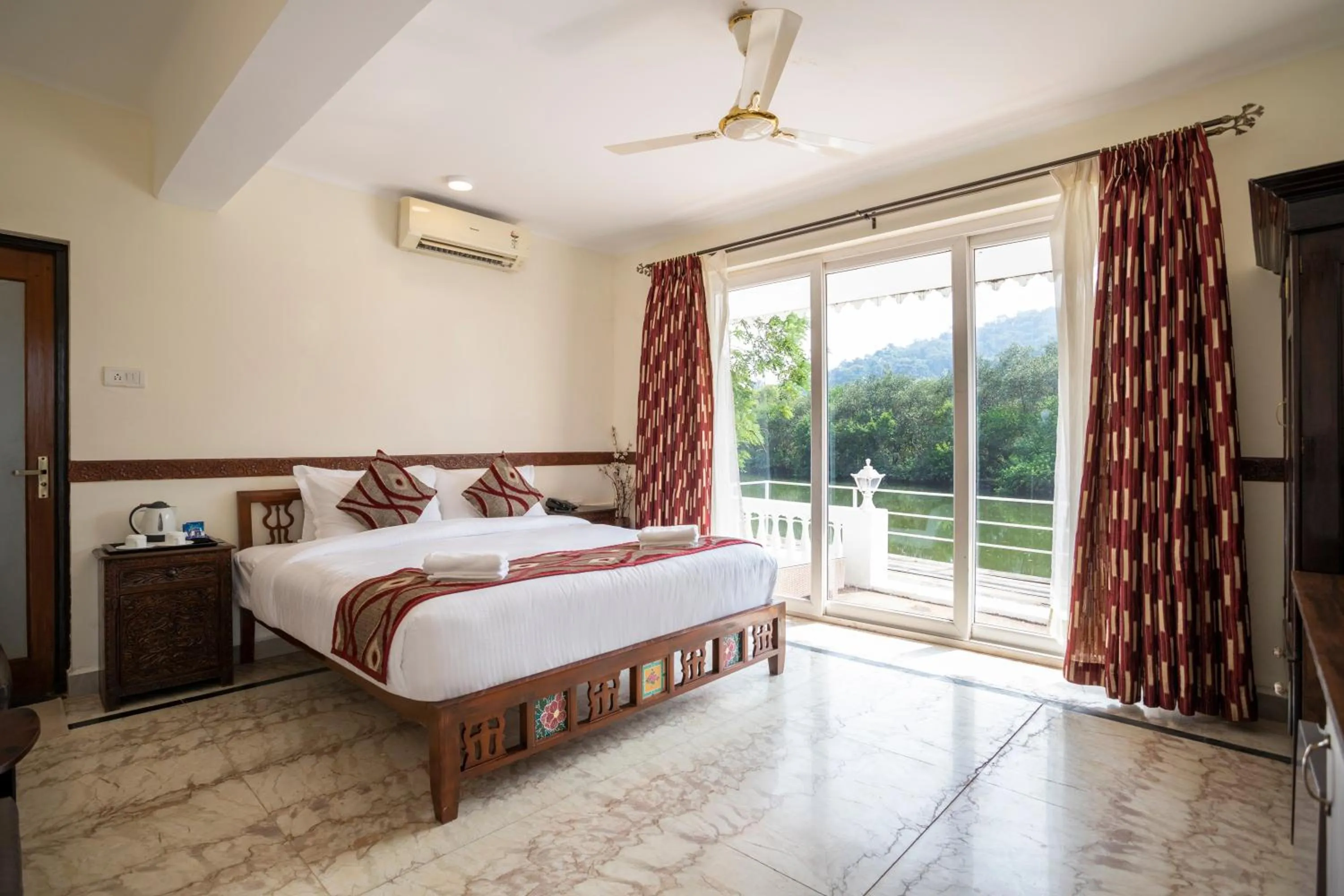 Bed in Stone Wood Riverfront Resort, Siolim