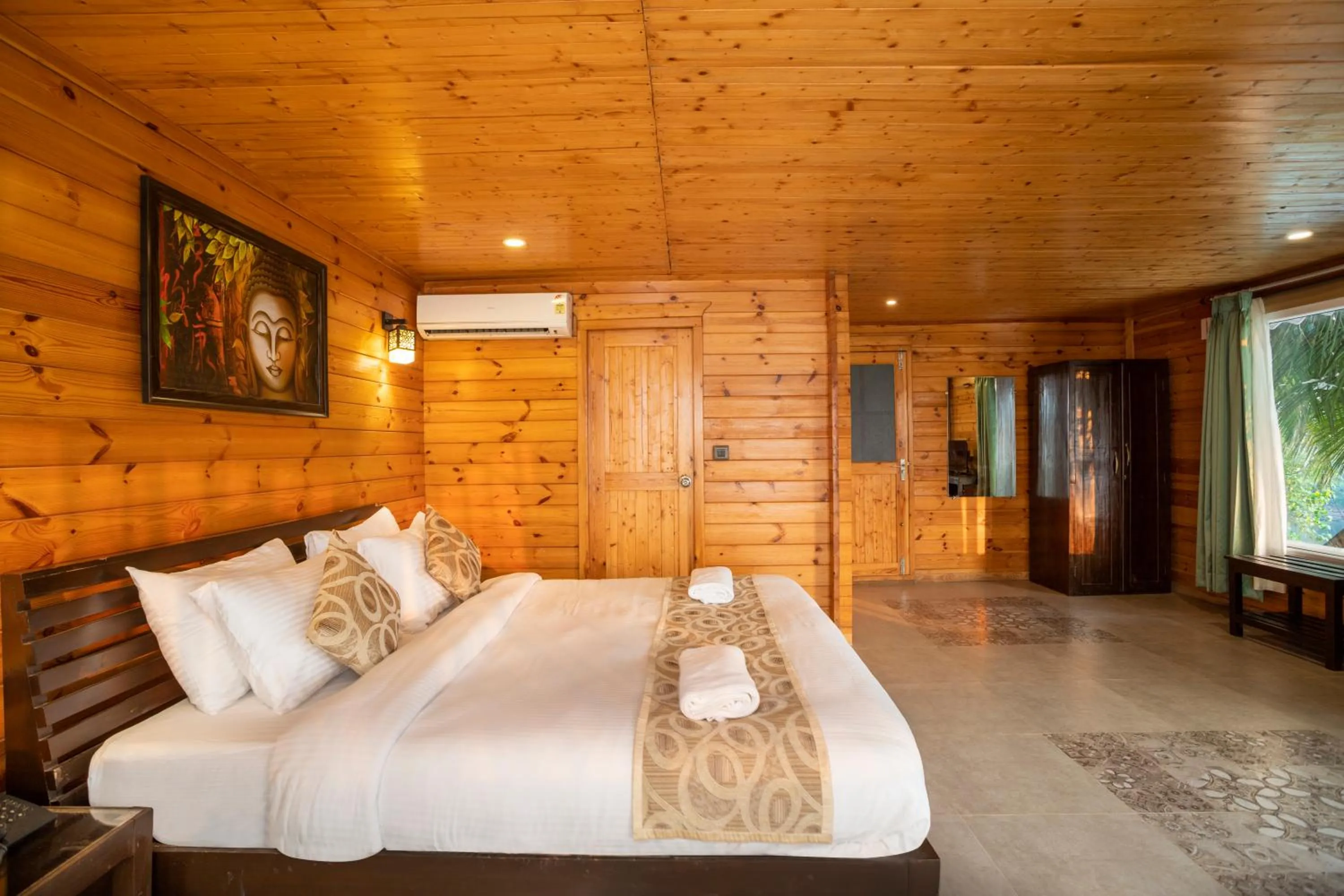 Bed in Stone Wood Riverfront Resort, Siolim
