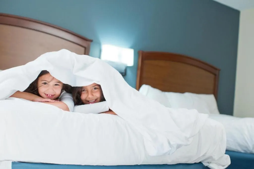 Bed in AmericInn by Wyndham Spencer