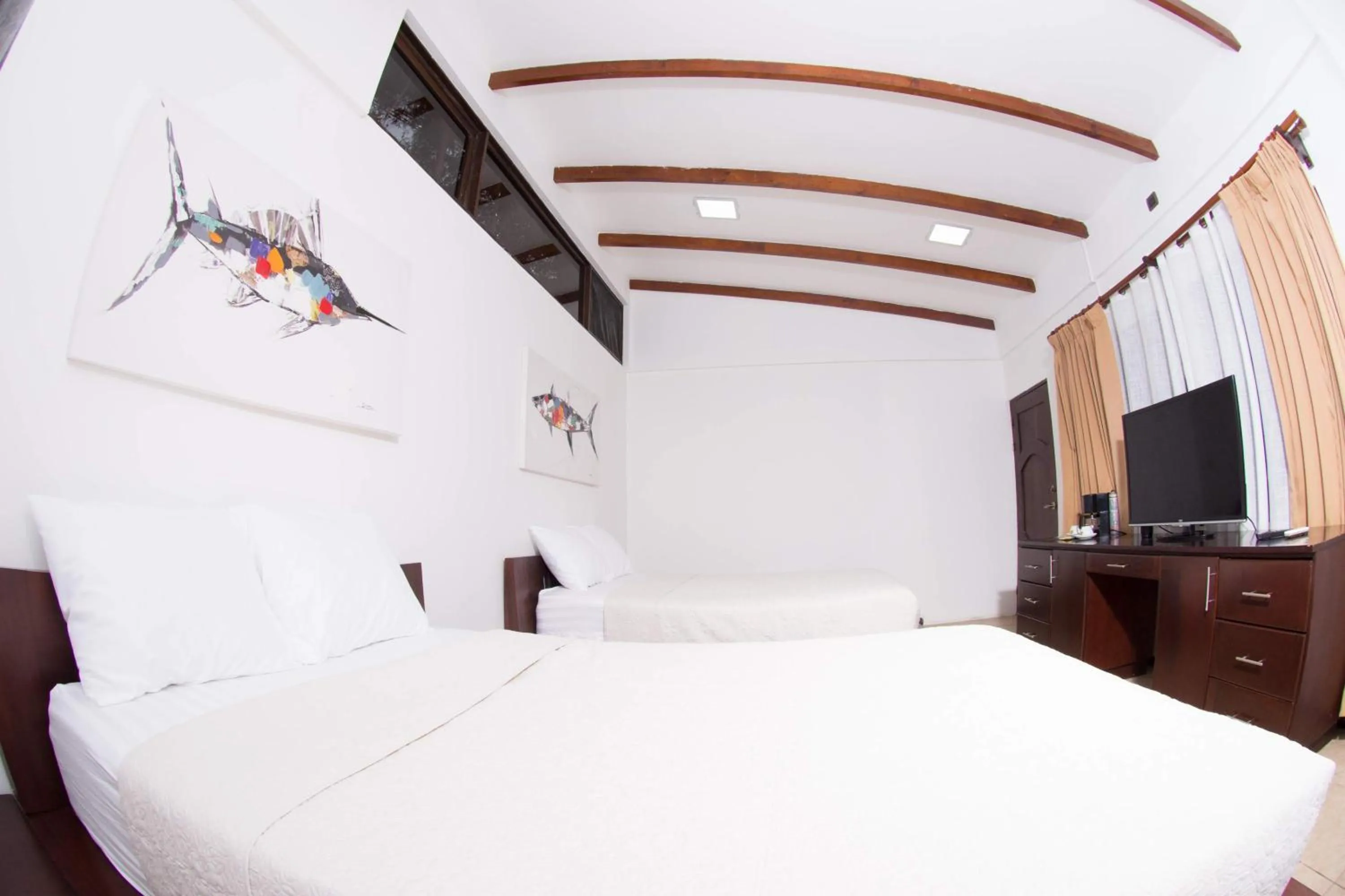 Bed in Café de Playa Beach Front Hotel