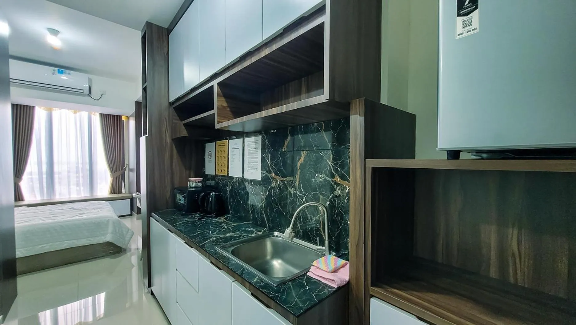 Kitchen or kitchenette in Palam Mansion at Meisterstadt Pollux Habibie Apartment