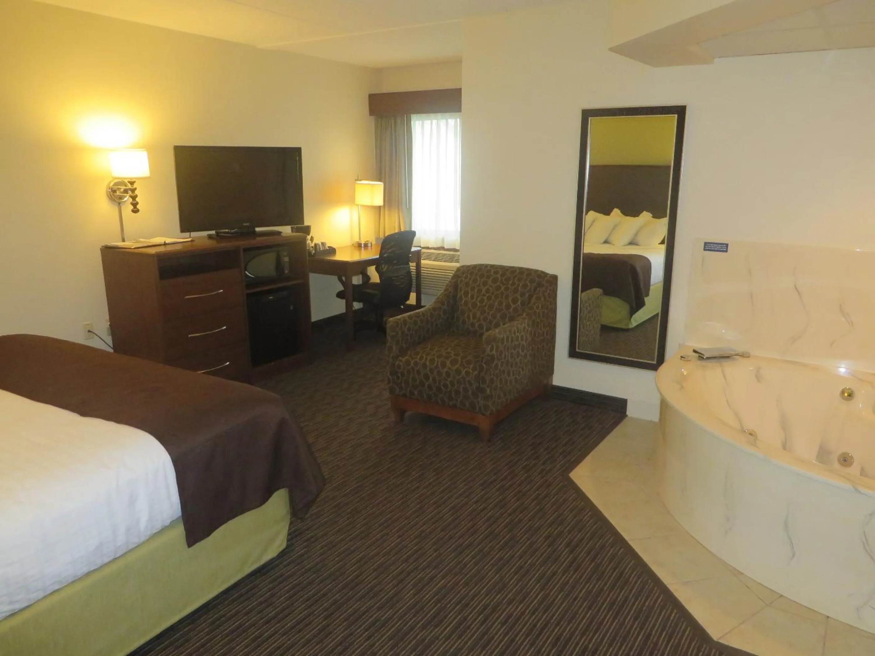 Bed in AmericInn by Wyndham Rice Lake