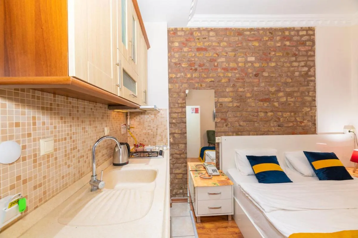 Kitchen or kitchenette, Bed in GRAND OPERA HOTEL