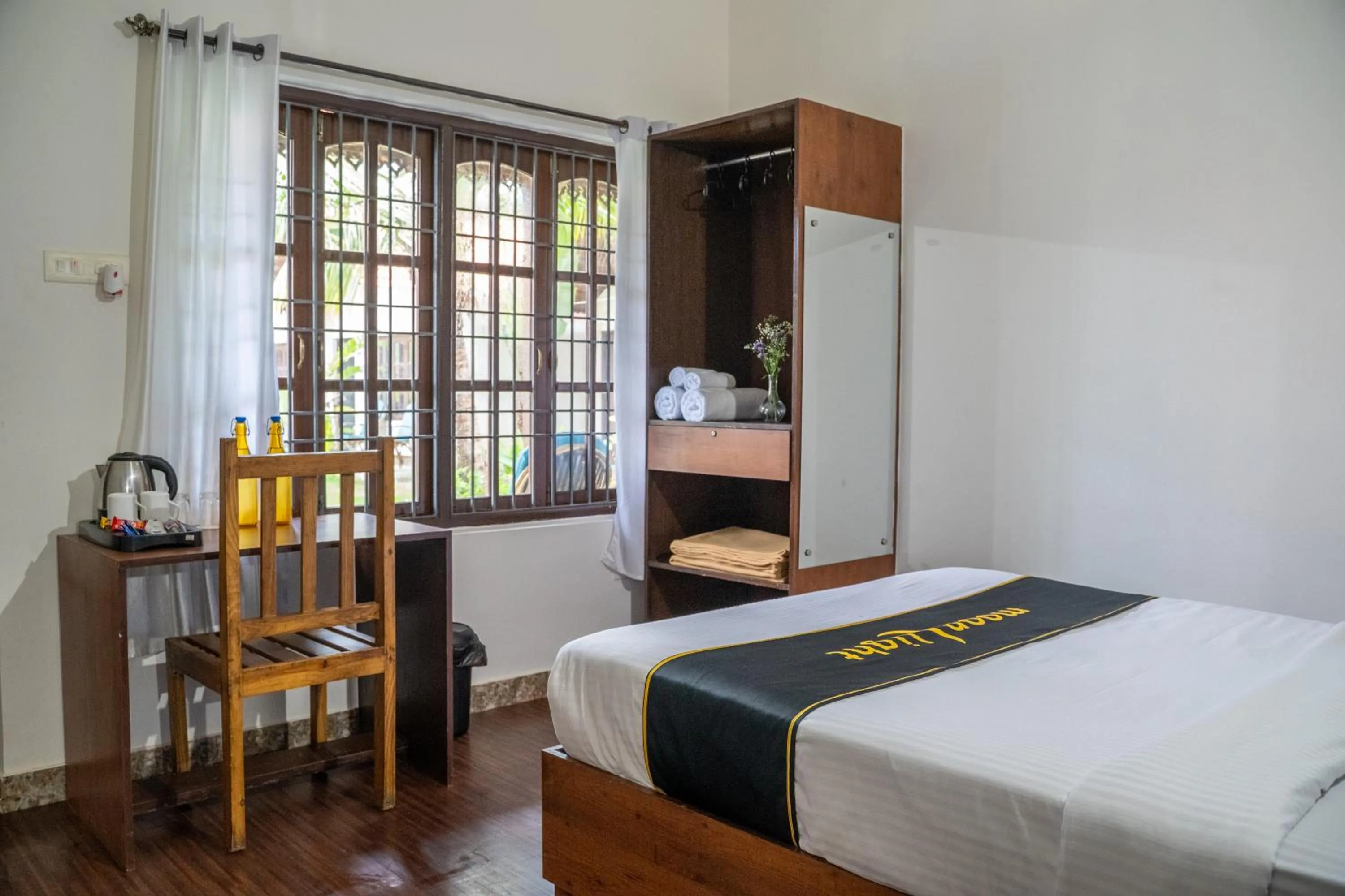 Bed in DhanRains Moonlight Retreat Cottages