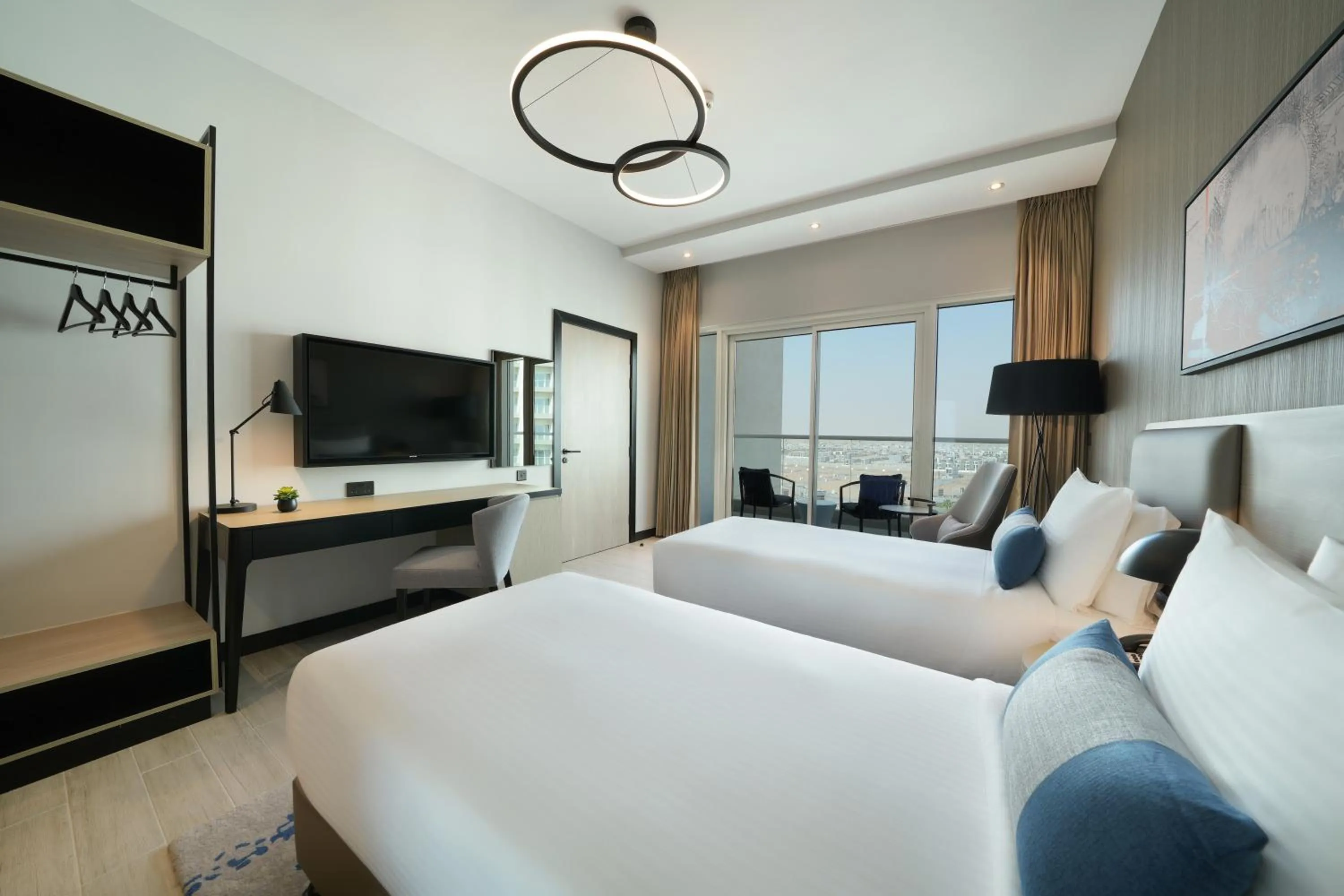 Bed in DAMAC Hills 2 Hotel, an Edge by Rotana Hotel