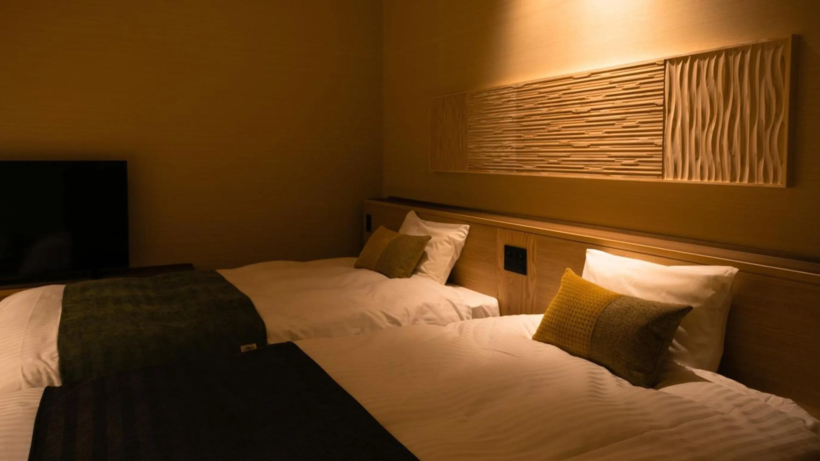 Bed in Kyukamura Retreat-Azumino-Hotel