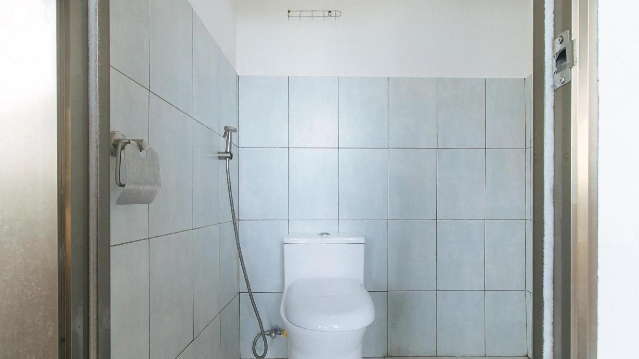 Shower in Marco s Tourist Inn by RedDoorz