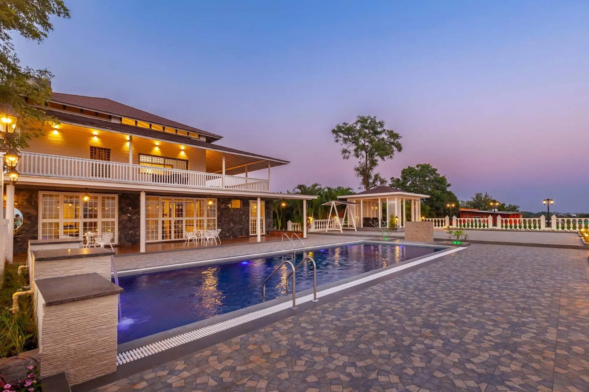 Property building in StayVista's Lake La Vie - Tranquil Lake-View Villa Amidst Farmland with Pool and Poolside Gazebo - Proximity to Sula