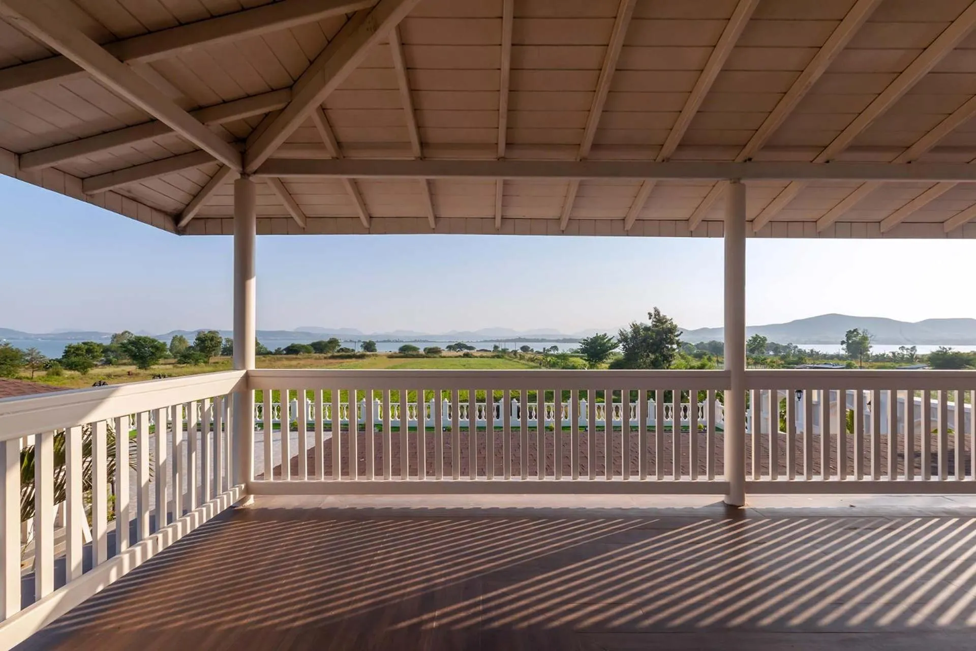 Balcony/Terrace in StayVista's Lake La Vie - Tranquil Lake-View Villa Amidst Farmland with Pool and Poolside Gazebo - Proximity to Sula