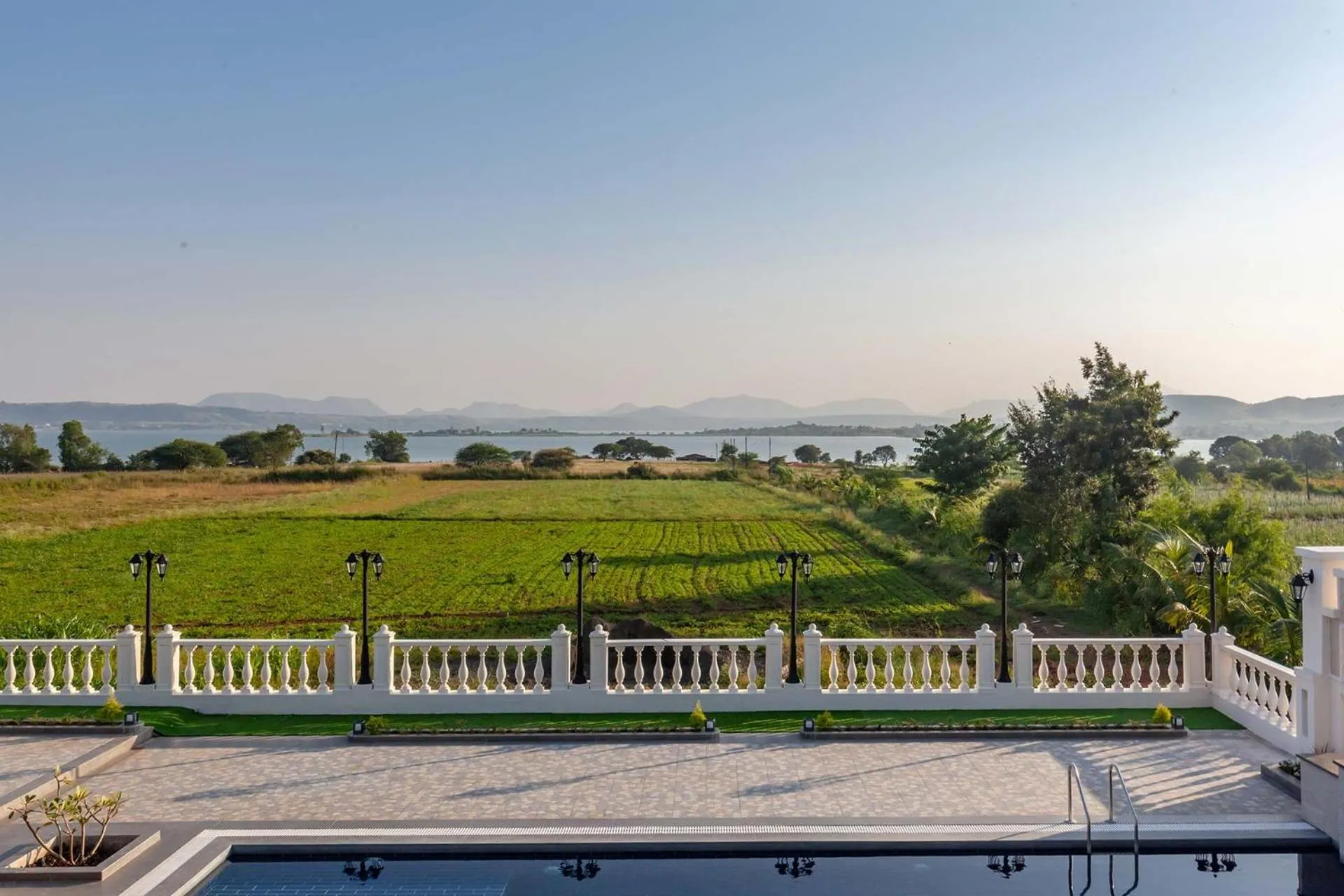 Balcony/Terrace in StayVista's Lake La Vie - Tranquil Lake-View Villa Amidst Farmland with Pool and Poolside Gazebo - Proximity to Sula