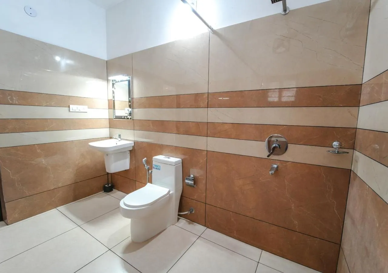 Toilet in Pop Tavern Kovalam Beach Villa by VOYE HOMES