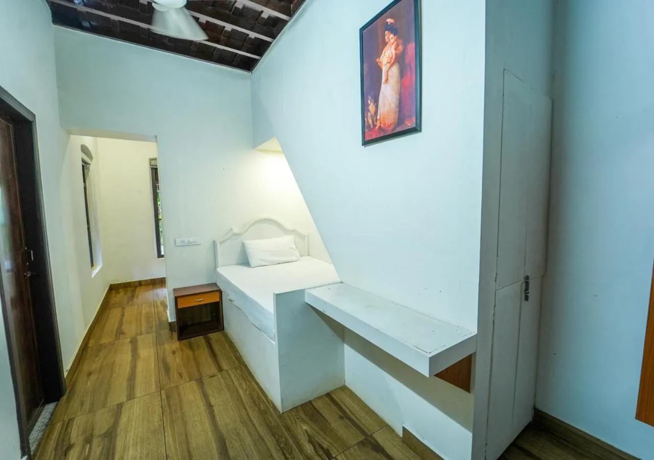 Bed in Pop Tavern Kovalam Beach Villa by VOYE HOMES