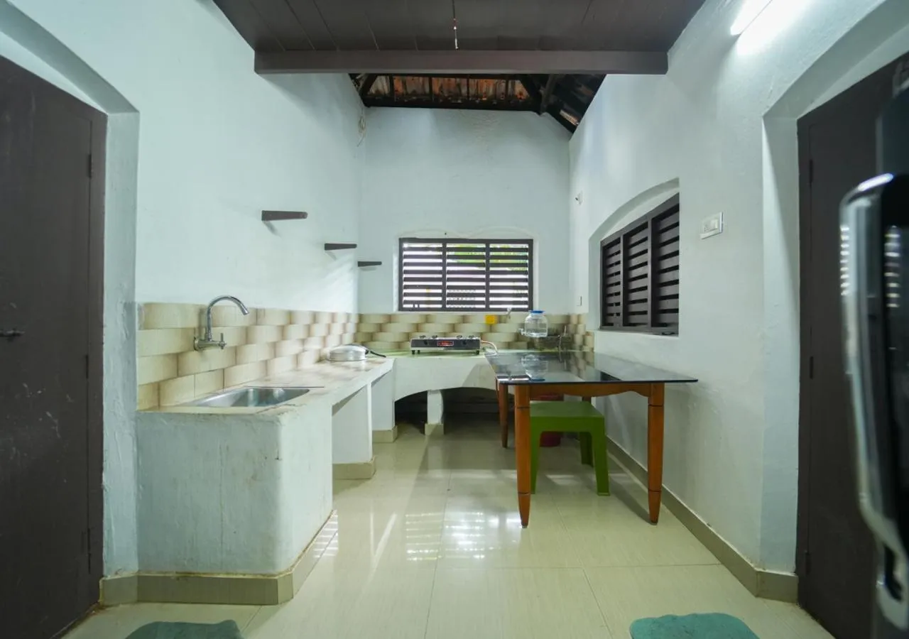 Kitchen or kitchenette in Pop Tavern Kovalam Beach Villa by VOYE HOMES