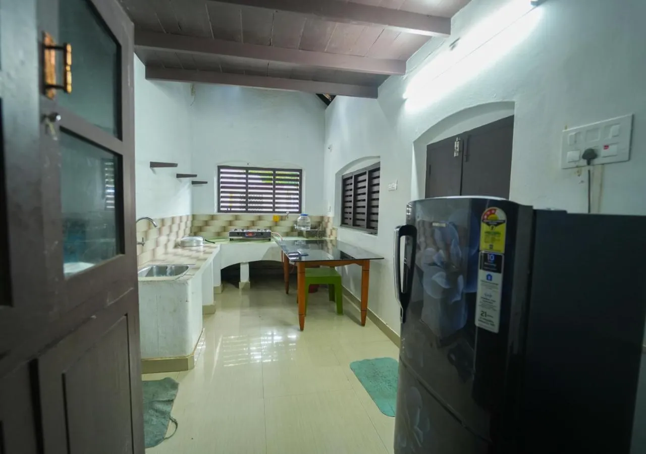 Kitchen or kitchenette in Pop Tavern Kovalam Beach Villa by VOYE HOMES