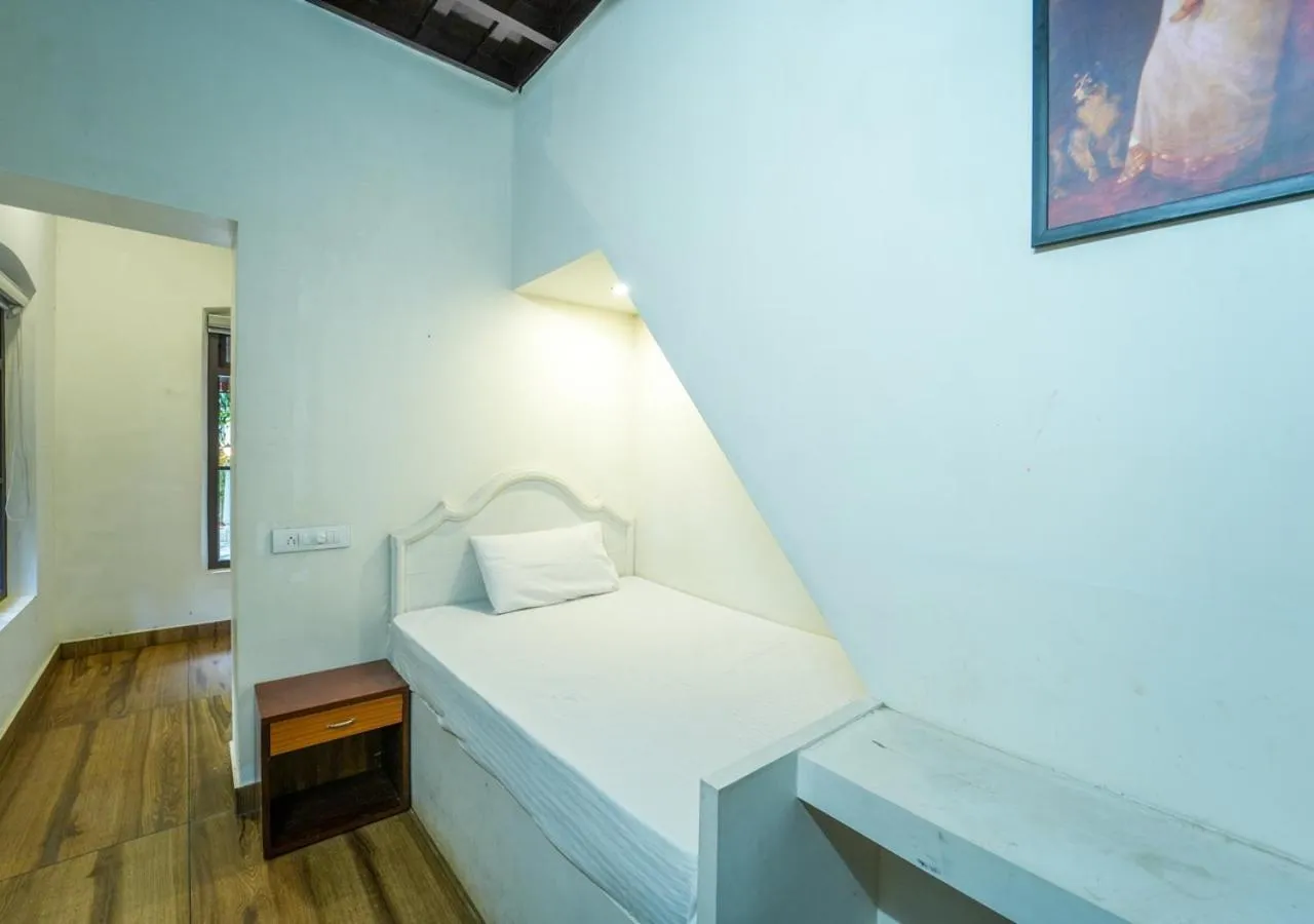 Bed in Pop Tavern Kovalam Beach Villa by VOYE HOMES