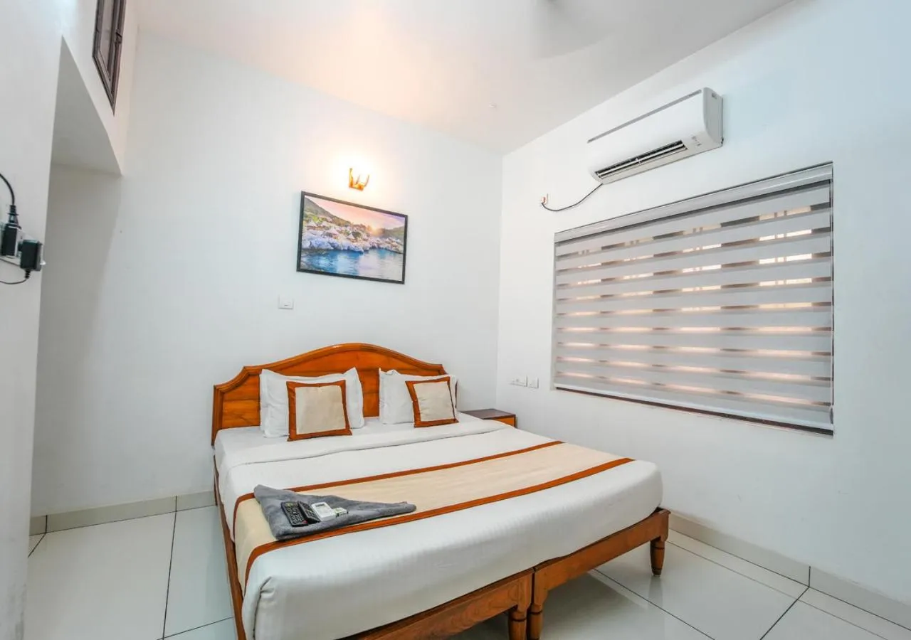 Bed in Pop Tavern Kovalam Beach Villa by VOYE HOMES