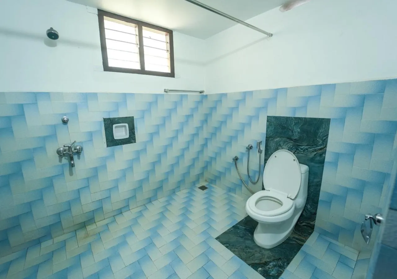 Toilet in Pop Tavern Kovalam Beach Villa by VOYE HOMES