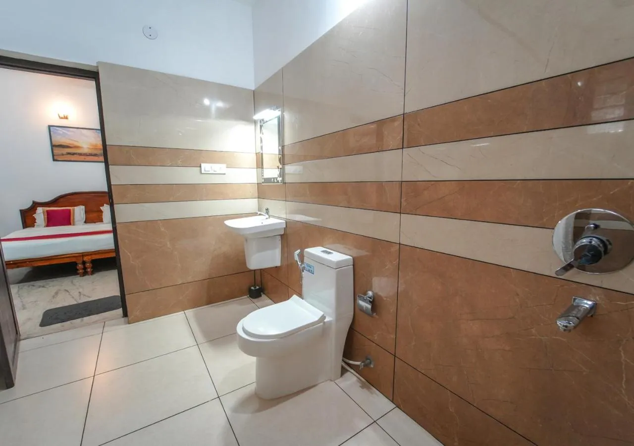 Shower in Pop Tavern Kovalam Beach Villa by VOYE HOMES