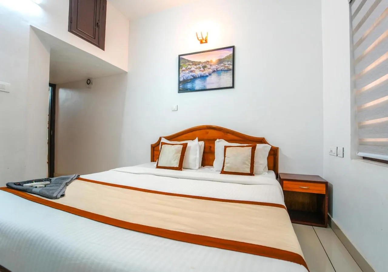 Bed in Pop Tavern Kovalam Beach Villa by VOYE HOMES
