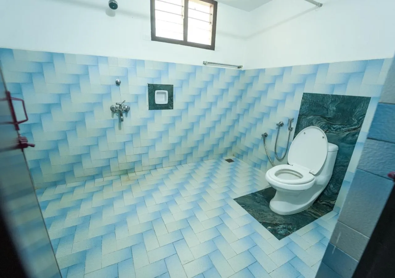 Toilet in Pop Tavern Kovalam Beach Villa by VOYE HOMES
