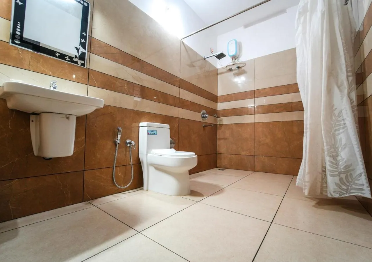 Shower in Pop Tavern Kovalam Beach Villa by VOYE HOMES