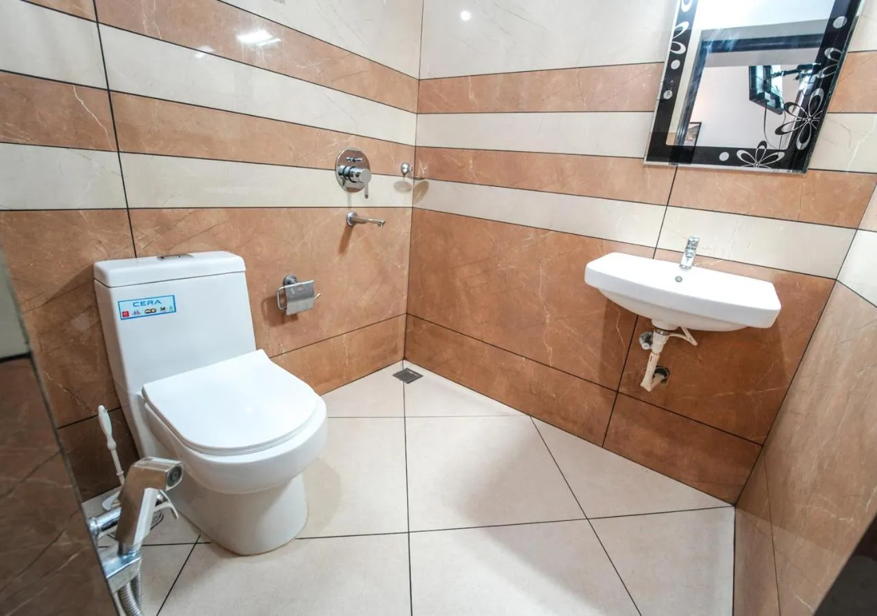 Shower in Pop Tavern Kovalam Beach Villa by VOYE HOMES