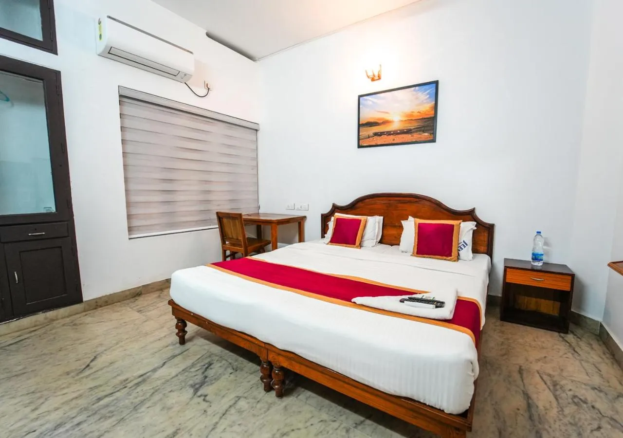 Bed in Pop Tavern Kovalam Beach Villa by VOYE HOMES