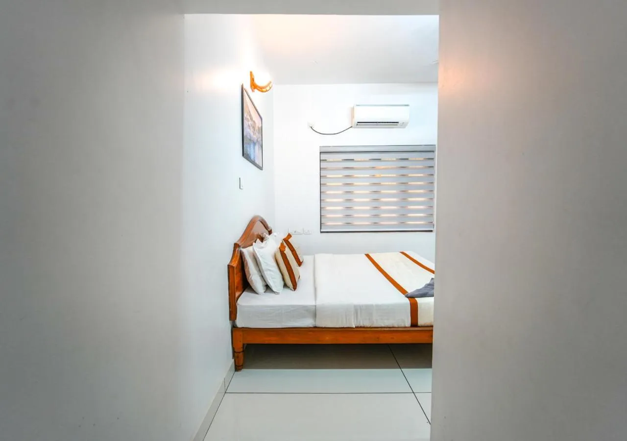 Bed in Pop Tavern Kovalam Beach Villa by VOYE HOMES