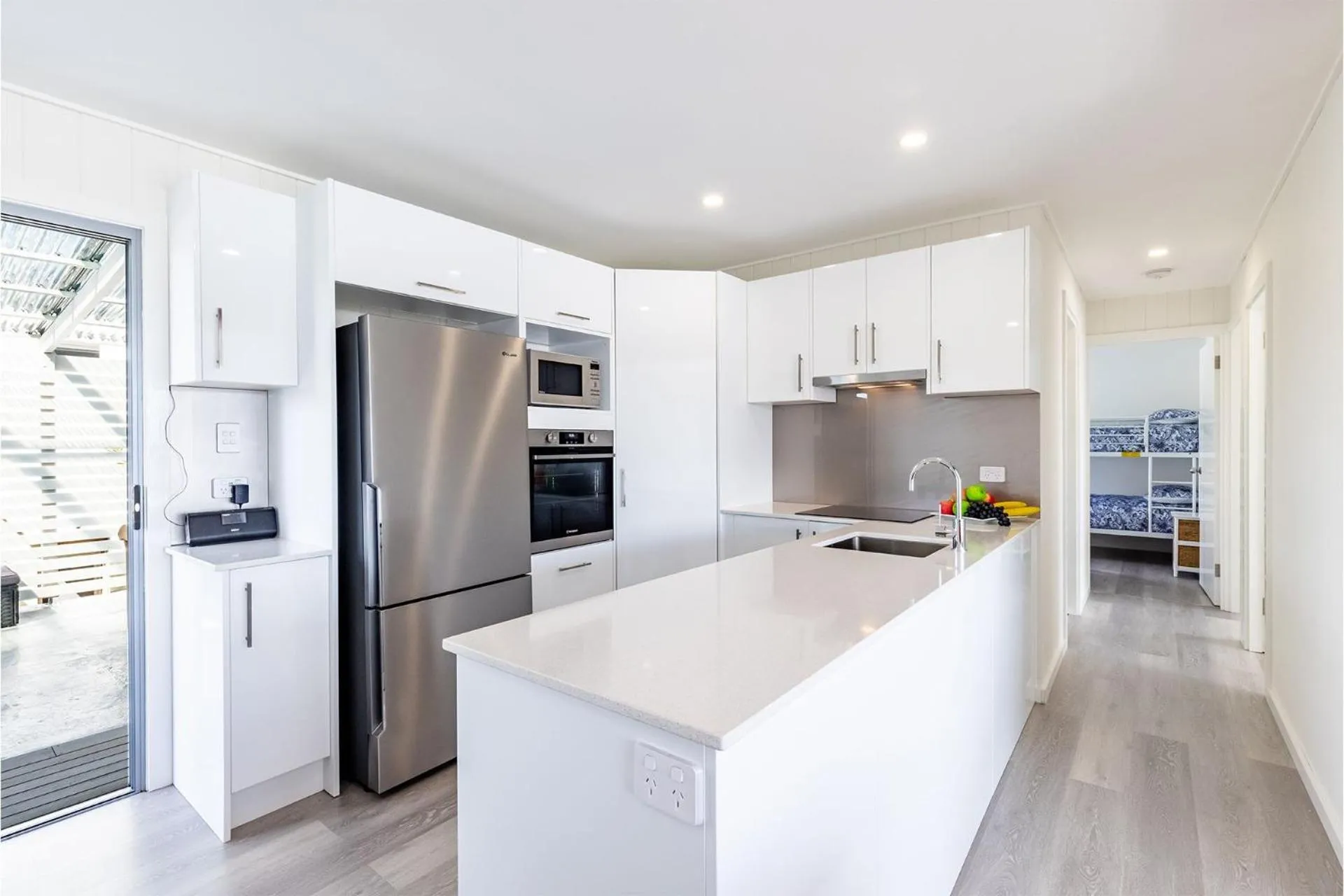 Kitchen or kitchenette in Five Pines Beach House at Birubi 20 Robinson St pet friendly aircon and WiFi